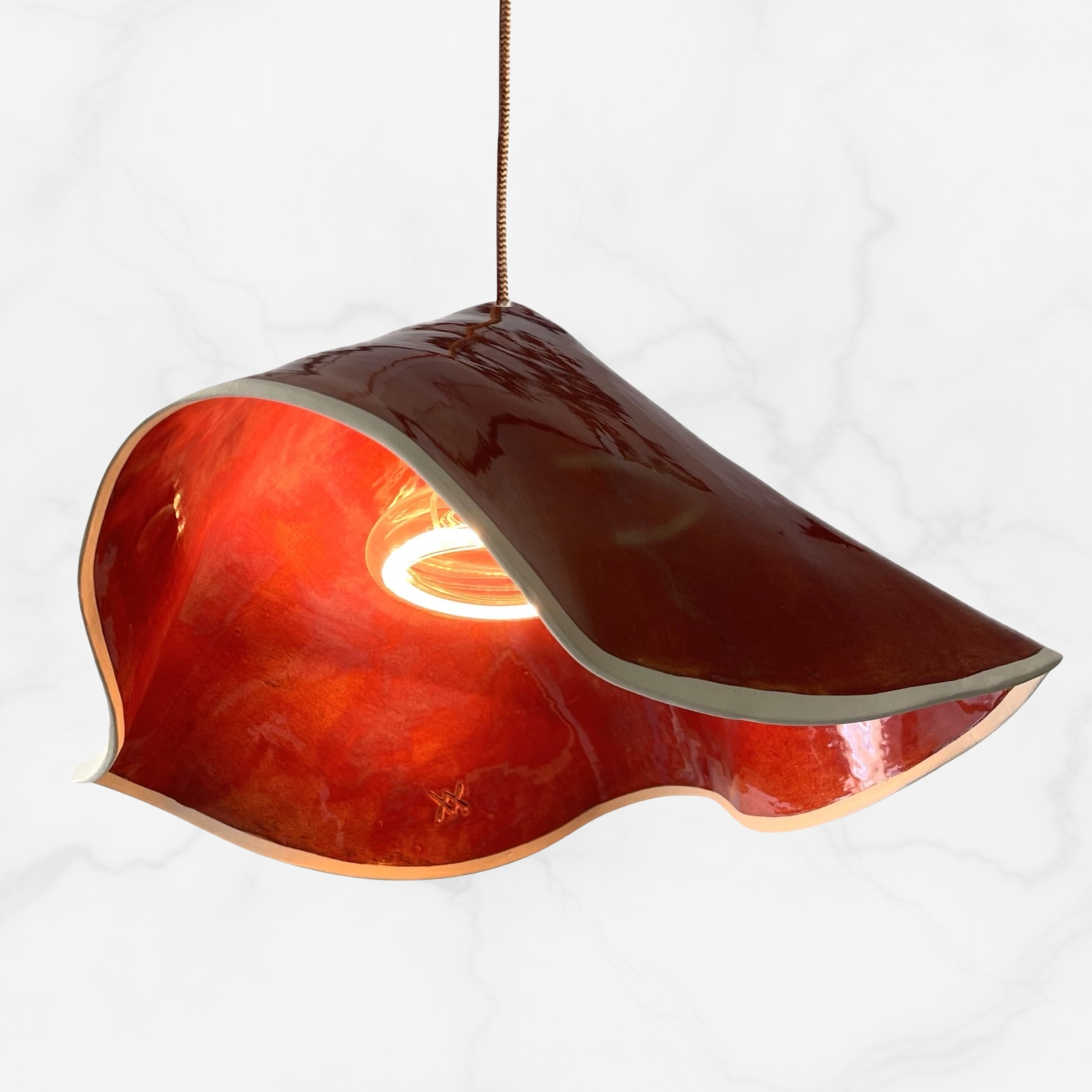 The Audrey pendant handcrafted ceramic pendant light Australia in burnt orange gloss glaze with folded sculptural ceramic shade