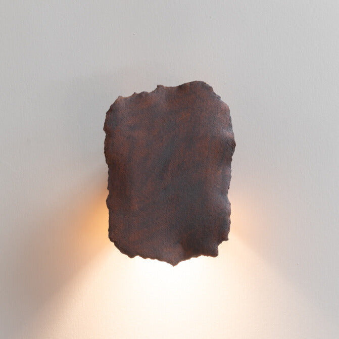 Bark Wall Sconce handcrafted ceramic wall light Australia lit showing warm ambient light cast upward and downward with textured surface