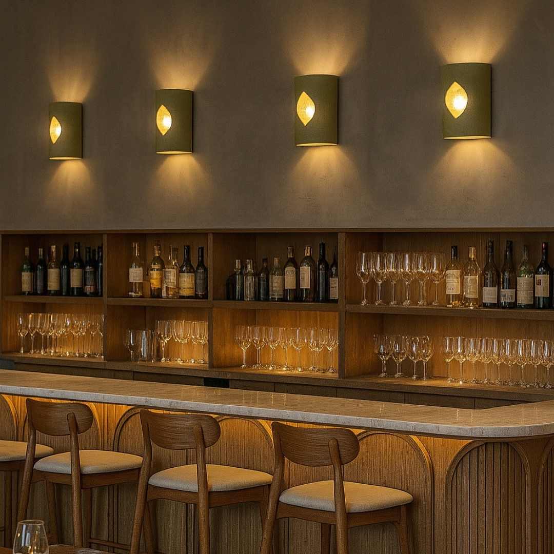 Four Beach Wall Sconce With Glass ceramic wall lights installed above a timber bar, casting warm ambient light over wine shelving, glassware and modern seating in a refined hospitality interior.