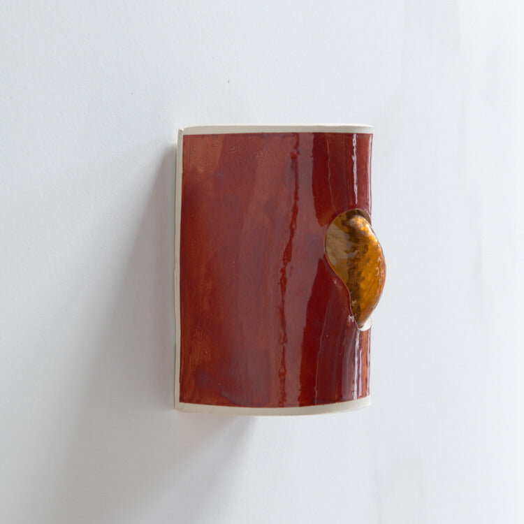 Burnt Orange Wall Sconce with Glass handcrafted ceramic wall light Australia showing side detail of glass emerging through ceramic form