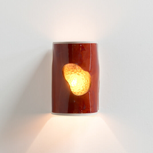 Burnt Orange Wall Sconce with Glass handcrafted ceramic wall light Australia with glowing glass insert lit with warm ambient light