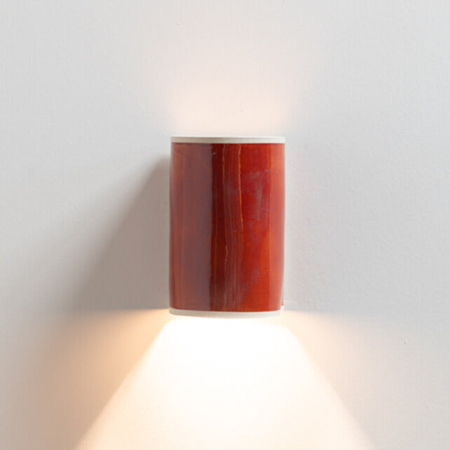 Burnt Orange Wall Sconce handcrafted ceramic wall light Australia lit showing warm ambient light cast downward
