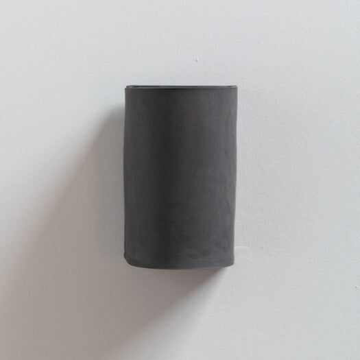 Charcoal Wall Sconce handcrafted ceramic wall light Australia with raw unglazed black clay finish on white background