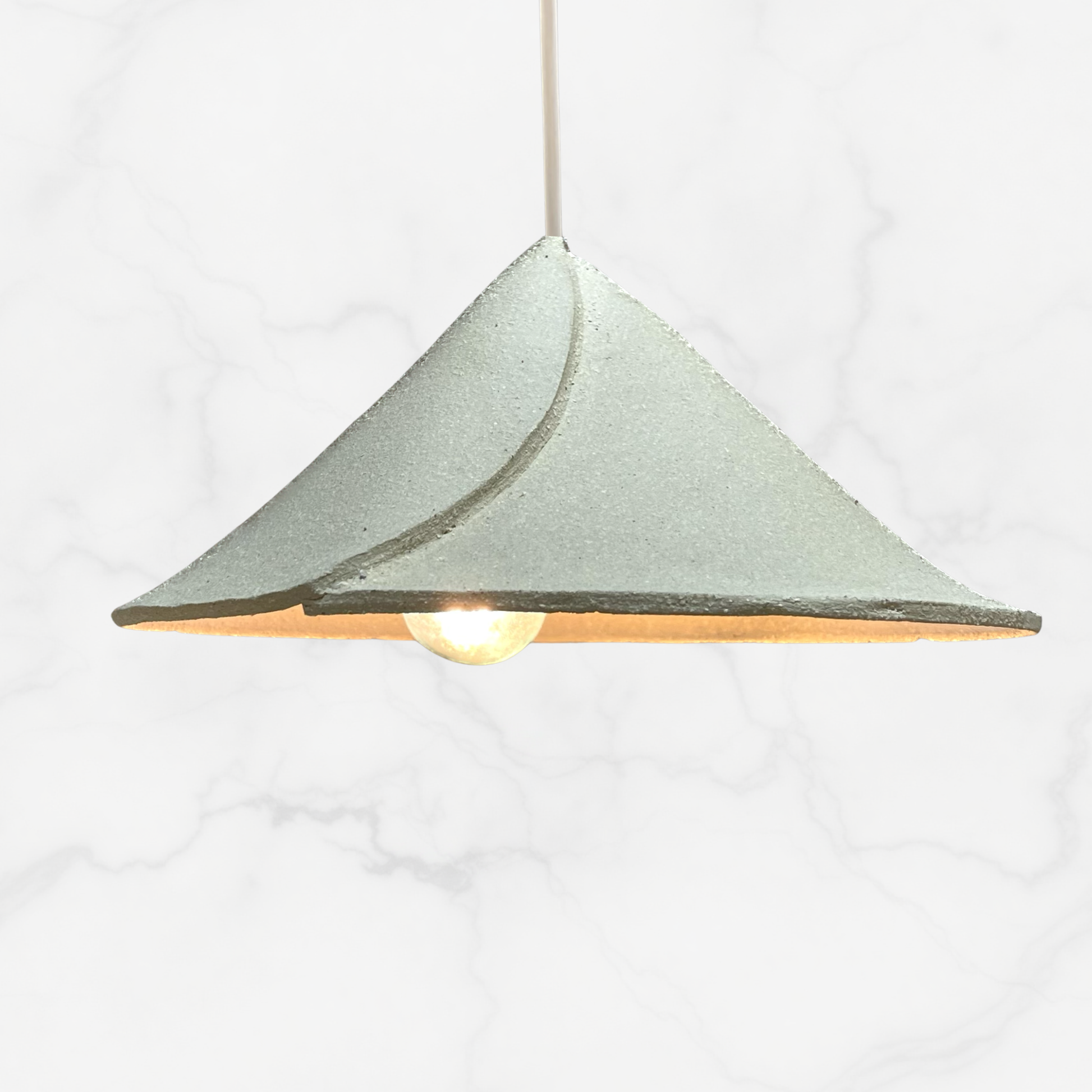 The Envelope pendant handcrafted ceramic pendant light Australia in sand coloured raw clay with folded form and soft diffused light