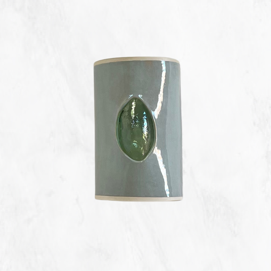 Eucalyptus glazed ceramic wall sconce with green textured glass, shown from the front.