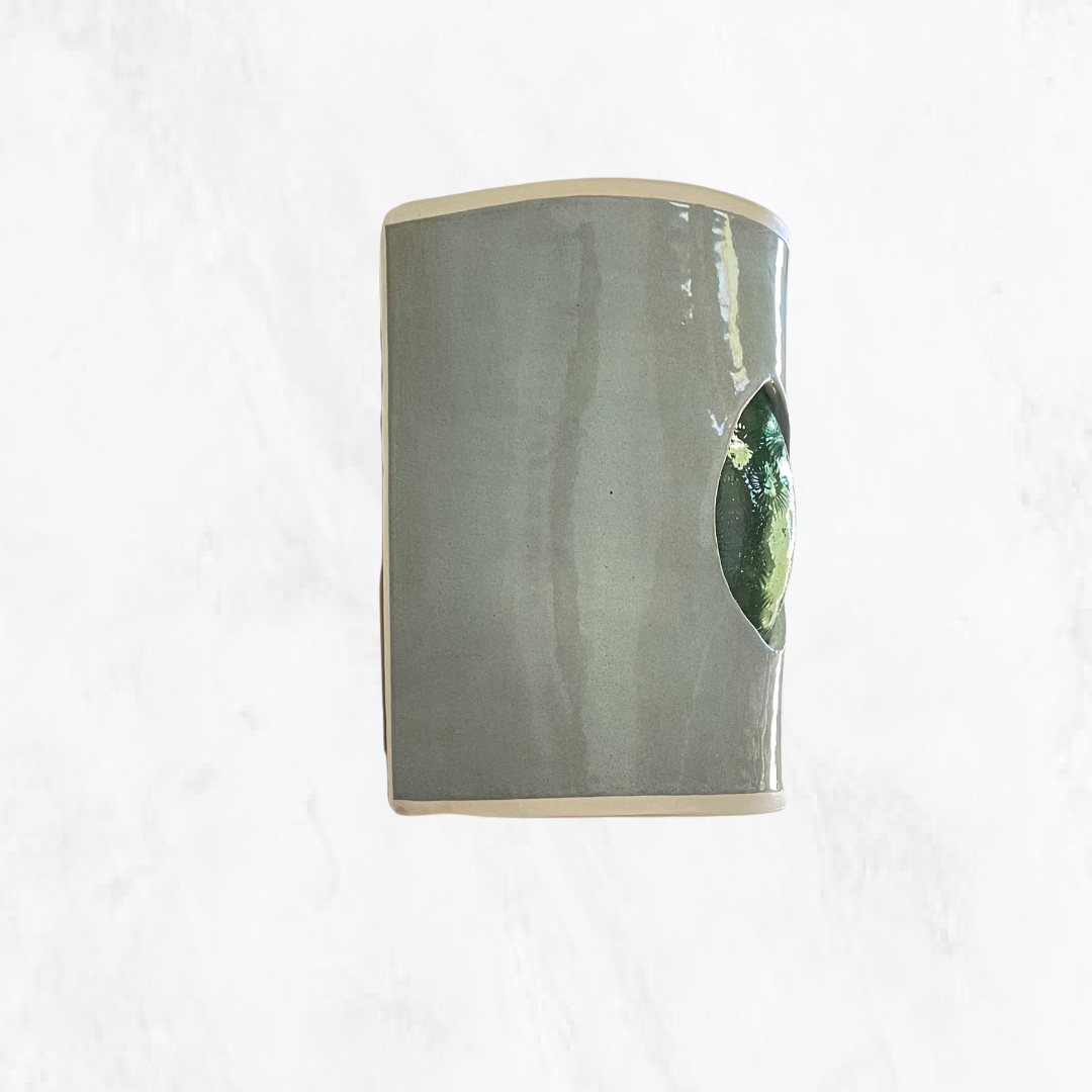 Eucalyptus glazed ceramic wall sconce with green textured glass, shown from the side.