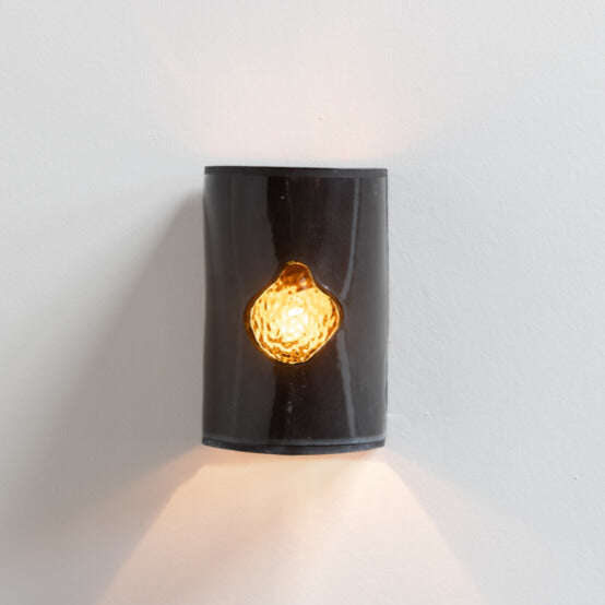 Gloss Black Wall Sconce with Glass handcrafted ceramic wall light Australia with glossy black finish and glowing glass insert lit with ambient light