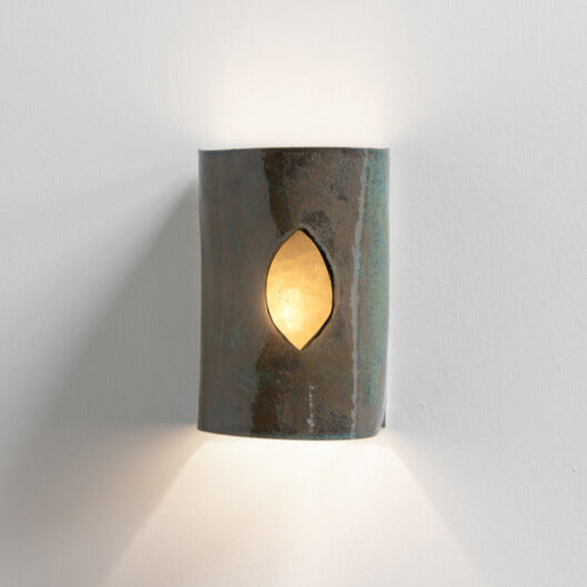 Green Stone Wall Sconce with Glass handcrafted ceramic wall light Australia lit showing glowing glass insert and warm ambient light