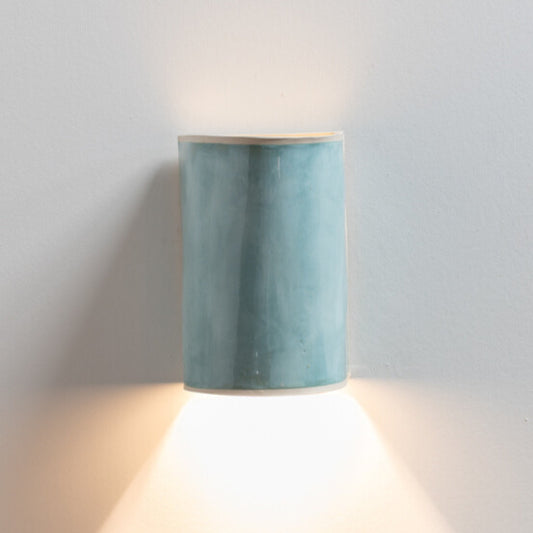 Lac Bleu Wall Sconce handcrafted ceramic wall light Australia lit showing warm ambient light cast upward and downward with soft blue glaze