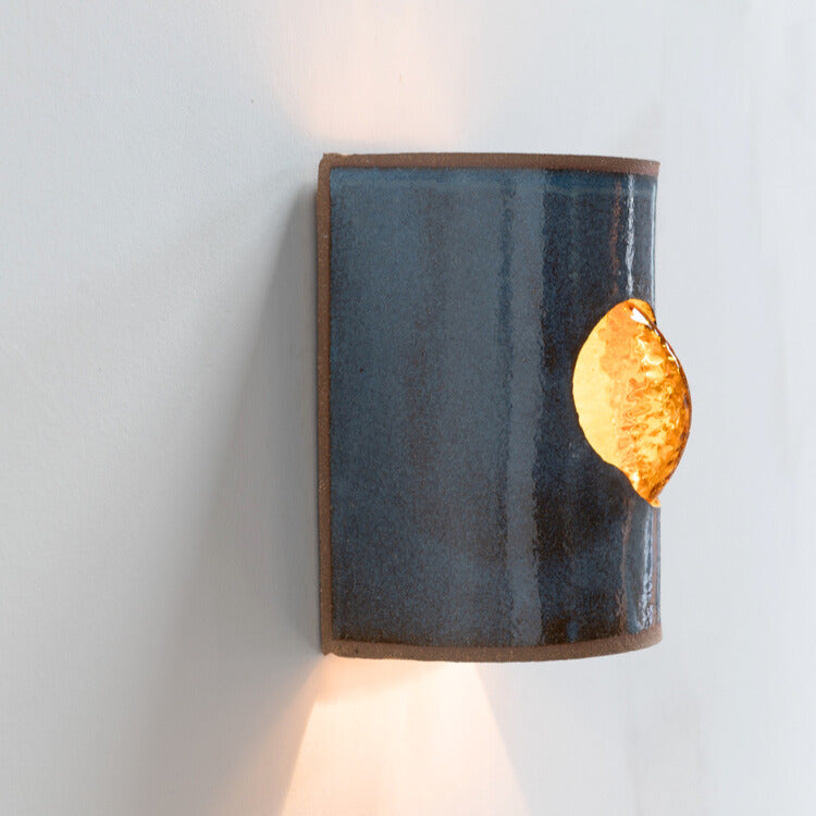 Midnight Blue Wall Sconce with Glass handcrafted ceramic wall light Australia lit from side angle showing glowing glass insert and ambient light