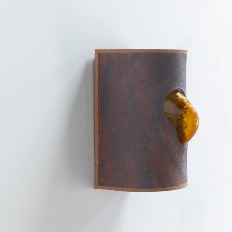 Rust Wall Sconce with Glass handcrafted ceramic wall light Australia showing side detail of glass emerging through ceramic form
