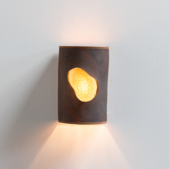 Rust Wall Sconce with Glass handcrafted ceramic wall light Australia lit showing glowing glass insert and warm ambient light