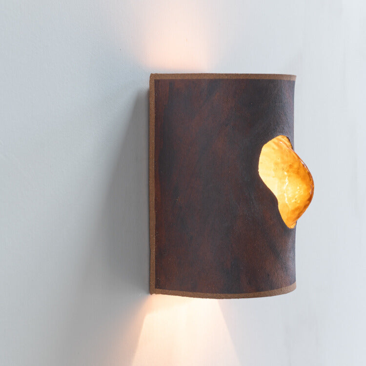 Rust Wall Sconce with Glass handcrafted ceramic wall light Australia lit from side angle showing glowing glass insert and ambient light