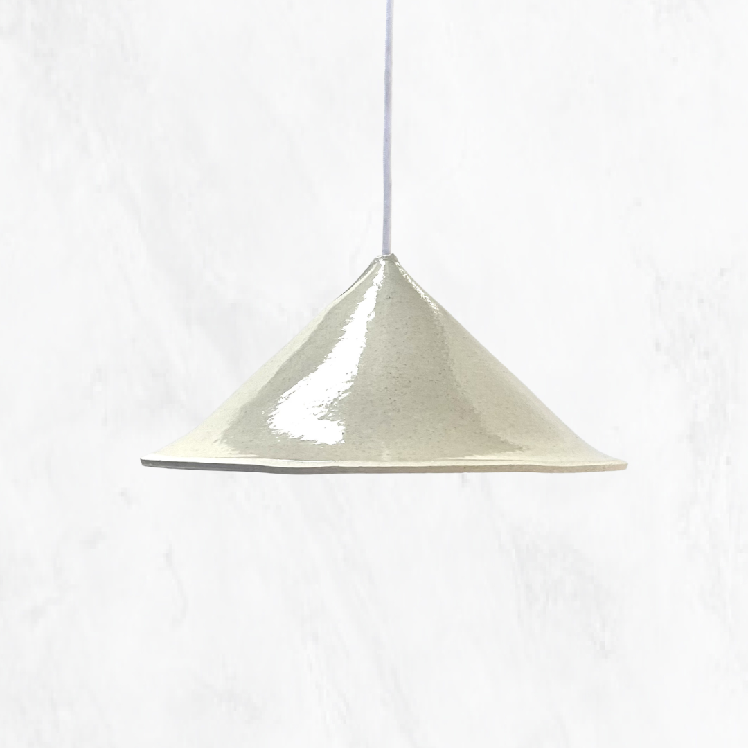 Stone Fuji handmade ceramic pendant light with a soft conical silhouette and glossy stone glaze, suspended on a white cord against a light textured background.