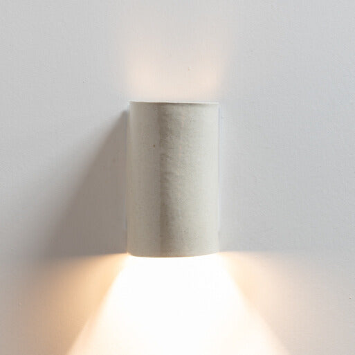 Stone Wall Sconce handcrafted ceramic wall light Australia lit showing warm ambient light cast upward and downward