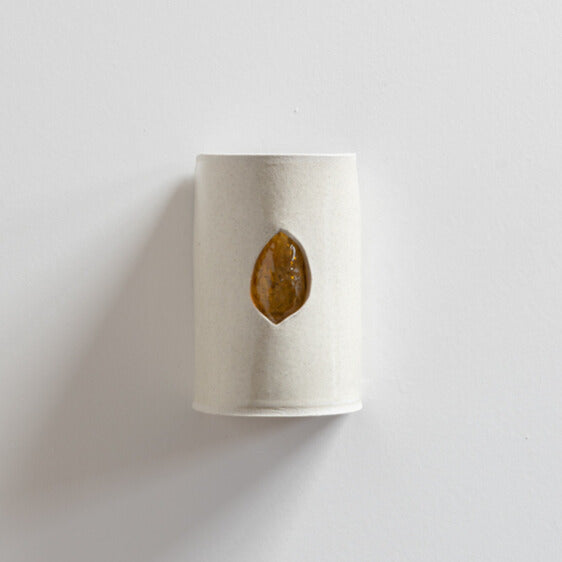 Stone Wall Sconce with Glass handcrafted ceramic wall light Australia showing glass emerging through stone-like ceramic surface