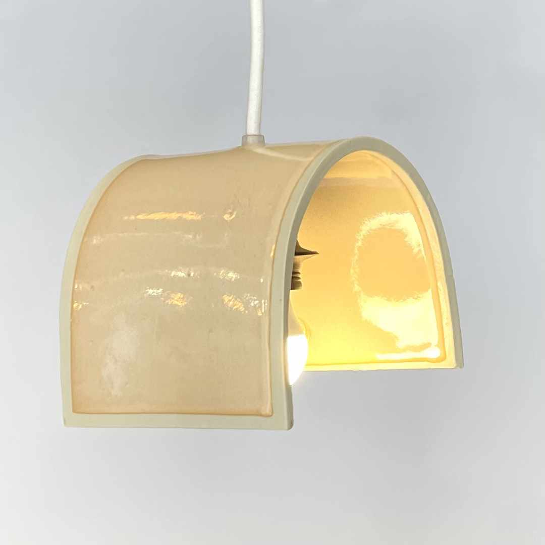 Tile pendant handcrafted ceramic pendant light Australia in coral gloss finish with arched form and warm internal glow