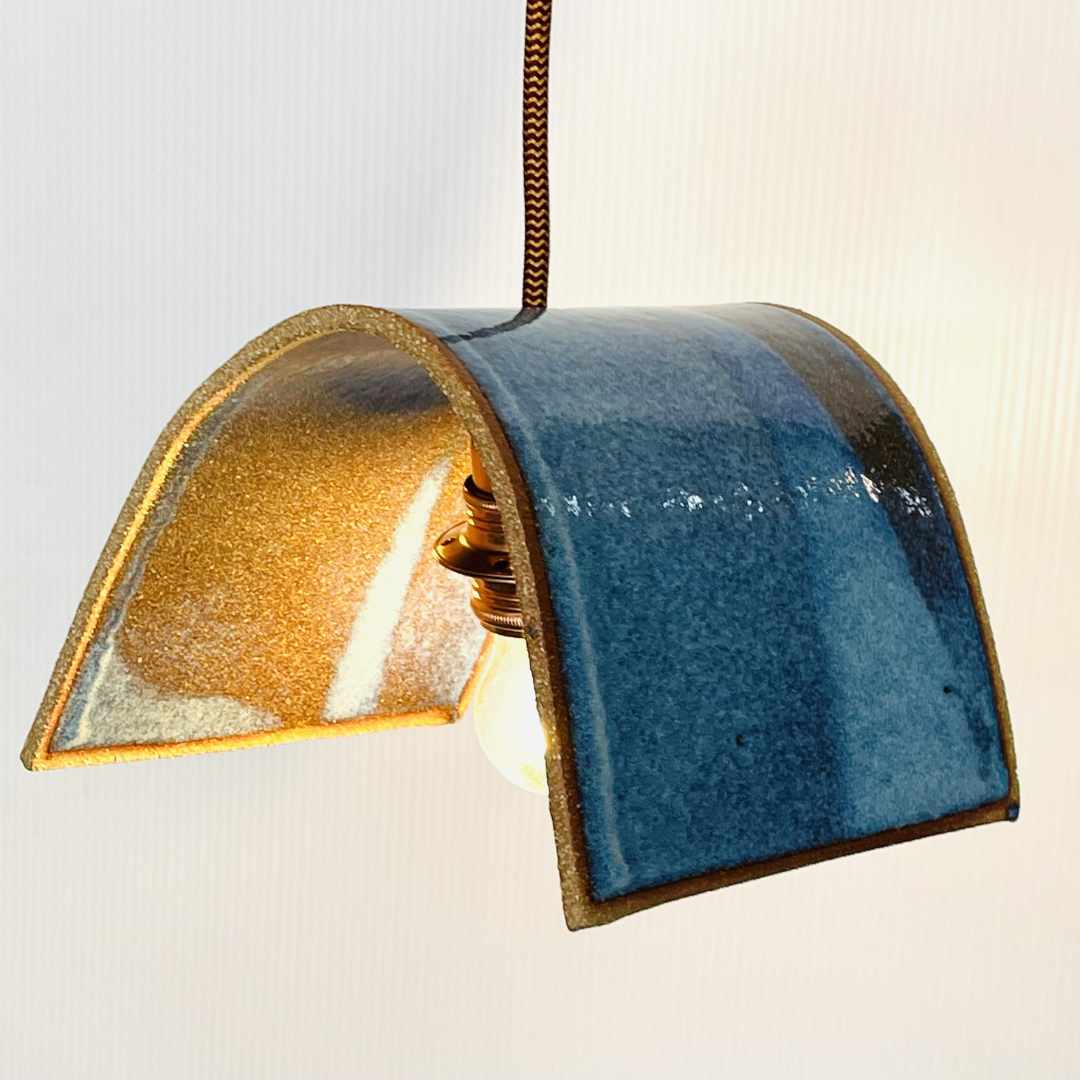 Tile pendant handcrafted ceramic pendant light Australia in midnight blue glaze with curved architectural form and warm glow