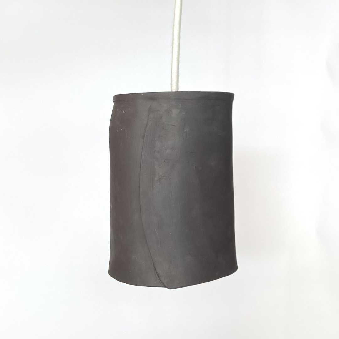 The Tumbler pendant handcrafted ceramic light Australia in matte charcoal finish with minimal cylindrical form